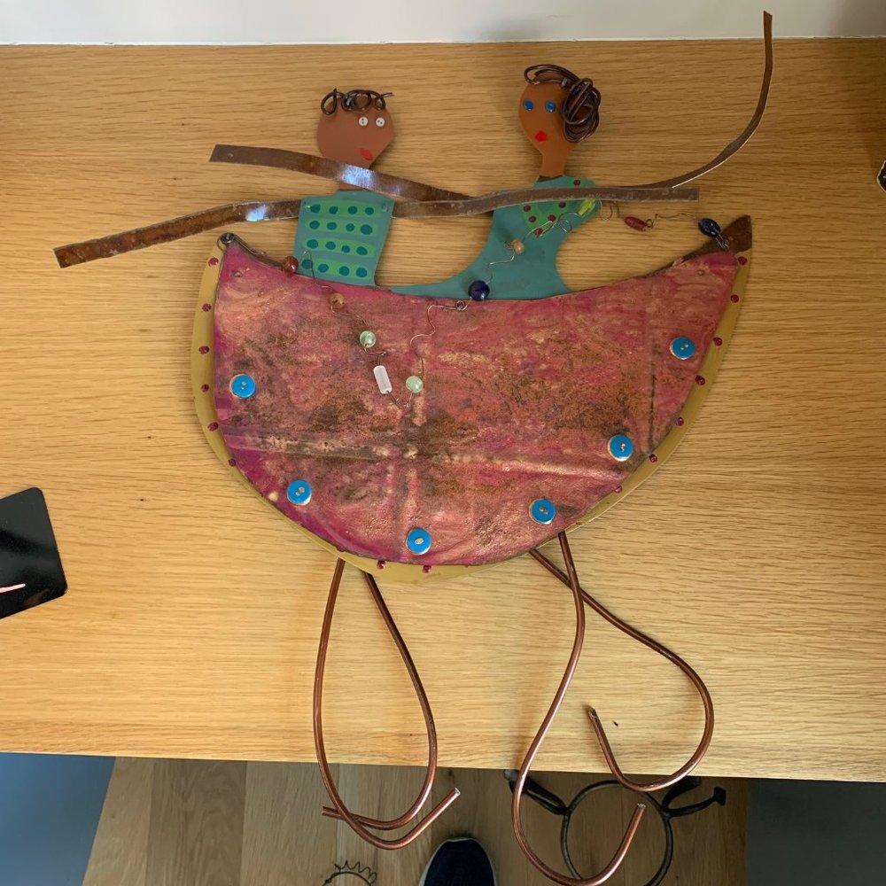 Primitive Rustic style,  Two people in a half moon.  Wall art is ~19W x 19H.